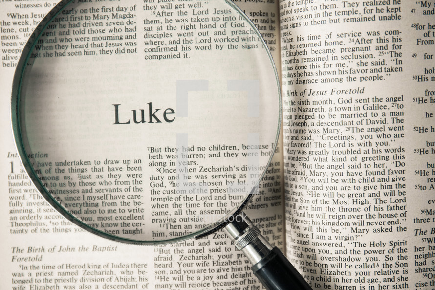 magnifying glass over Bible - Luke 