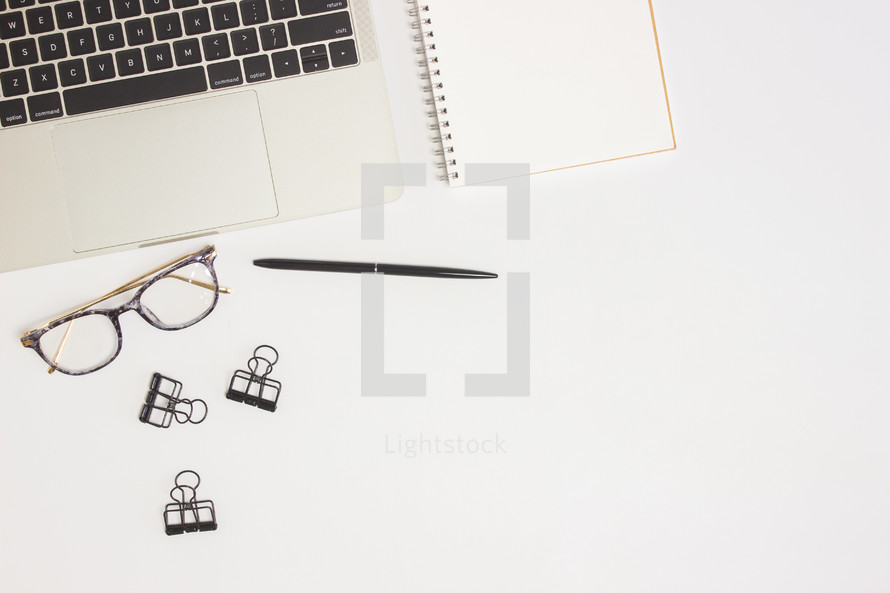 glasses on a computer desk 