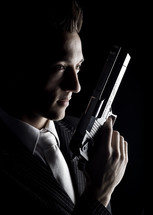 White-Collar Crime; man in suit holding pistol.