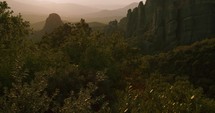 The incredible Meteora, Greece on a summers evening. Slow pan up gimbal shot.