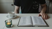 man sitting down to read a Bible with coffee 