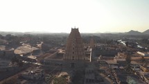 Top view of Virupaksha Temple amidst near the banks of Tungabhadra River in Hampi, India - Aerial Orbit Point of interest shot