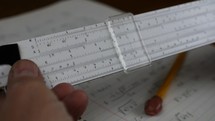 Using a vintage slide rule to do math calculations