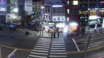Timelapse of cars and pedestrians traffic on night road