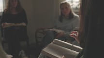 Close up of young woman speaking at a small group women's bible study.