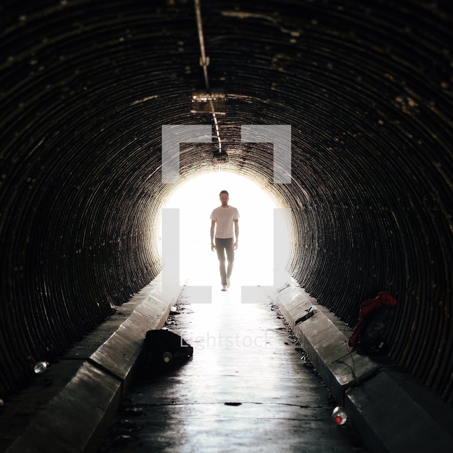 man walking in a tunnel 