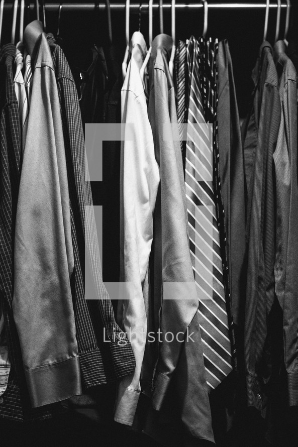 Men's shirts hanging in a closet.