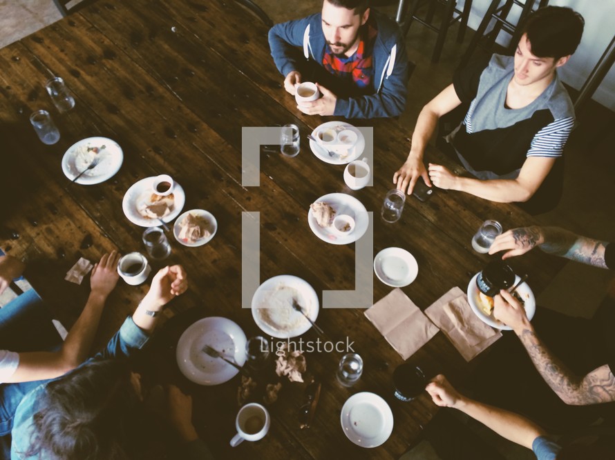 family eating a meal together gathered around a table  