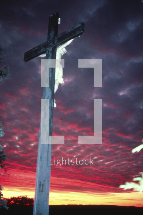 Crucifix in a cemetery at sunset 