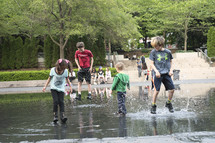 kids splashing in a puddle 