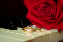 gold wedding rings on a piano
