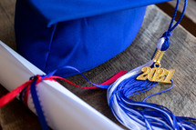 blue graduation cap with 2021 tassel and diploma 