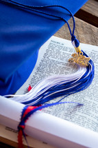 blue graduation cap with 2021 tassel and diploma on a Bible 