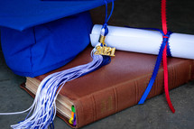 diploma, Bible, and blue graduation cap with 2021 tassel 