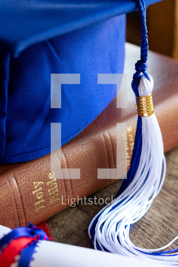 blue graduation cap with 2021 tassel and Bible and diploma 