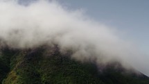clouds forming on a mountain peak 