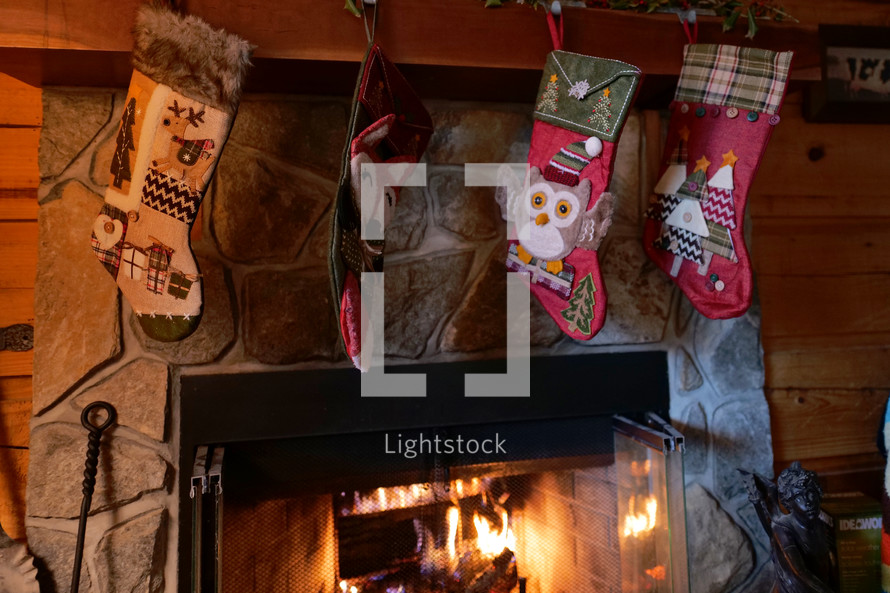 Christmas stockings hung over a fireplace 