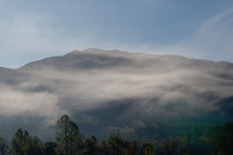 dense fog over a mountain landscape 
