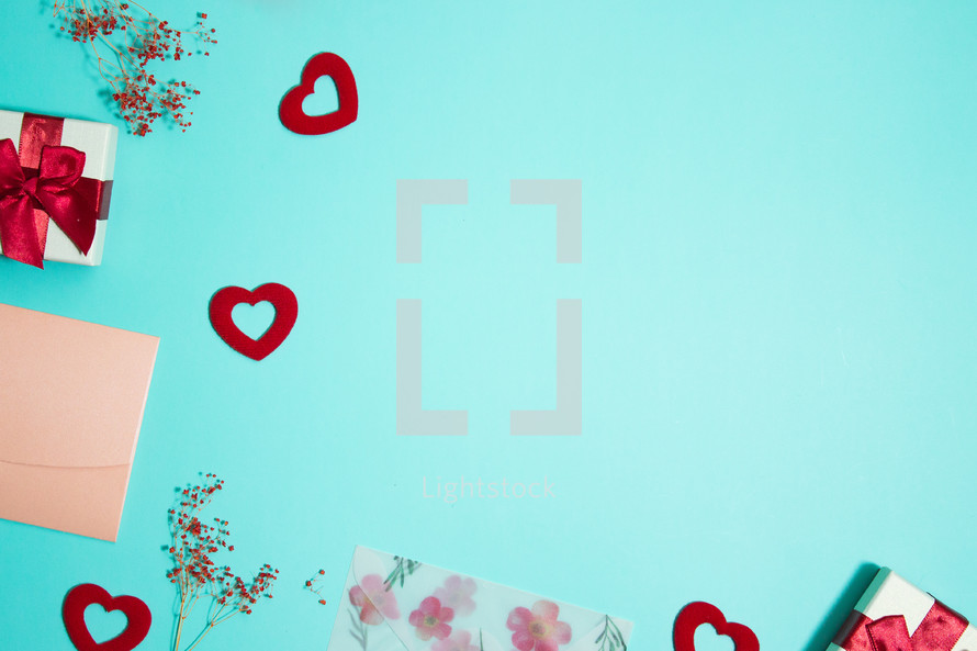 red hearts, and gift on turquoise background 