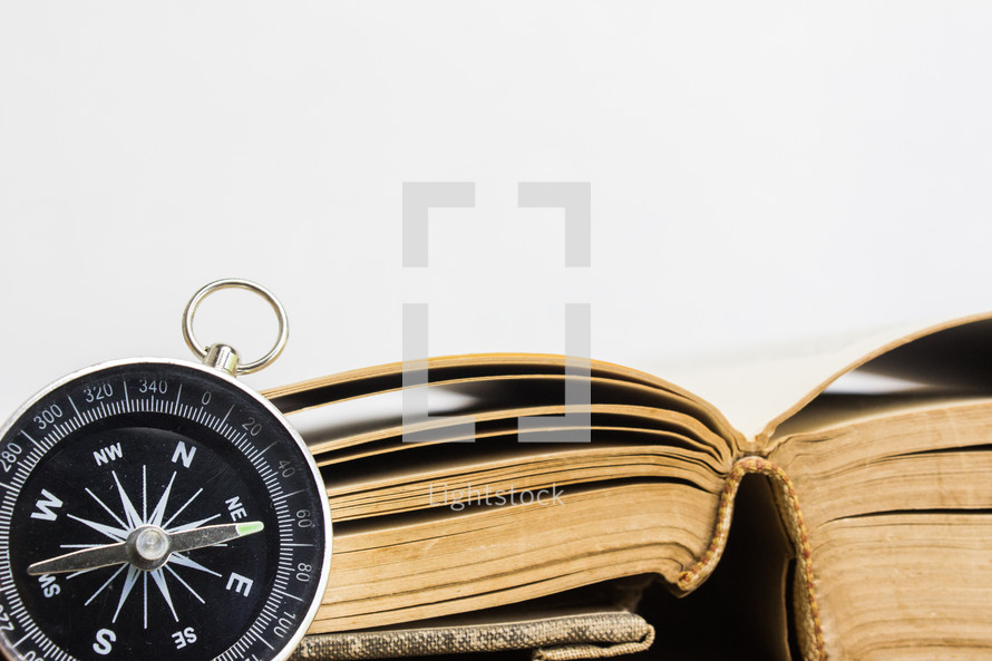 compass and open Bible 