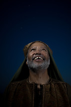 face of a smiling wiseman looking up 