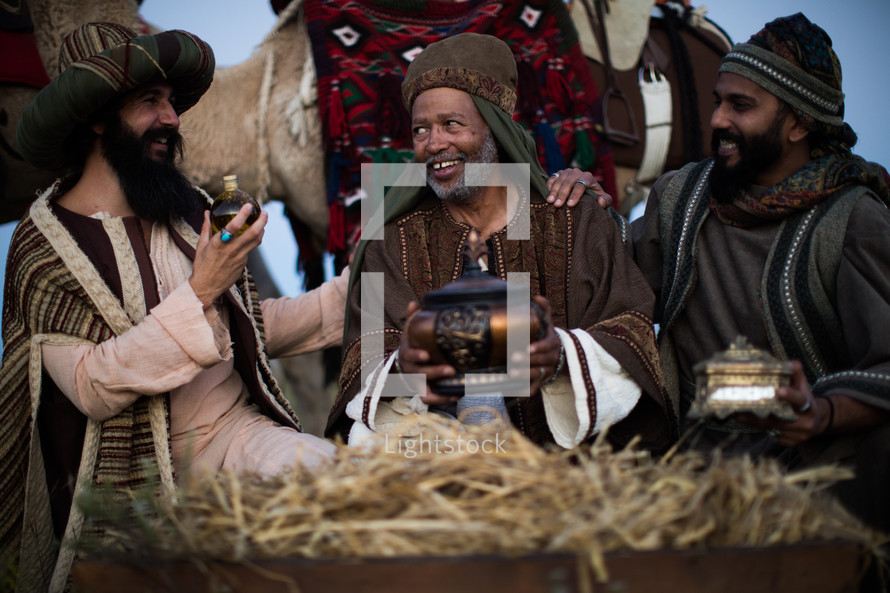 wisemen traveling on camels presenting gifts to baby Jesus 