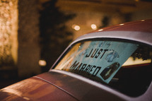 "Just Married" sign in back car window