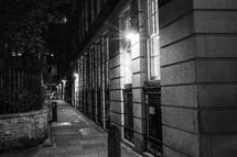 downtown city sidewalk at night 
