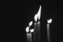 flames on candles in darkness 