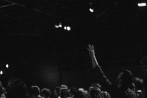 raised hands in an audience at a concert 