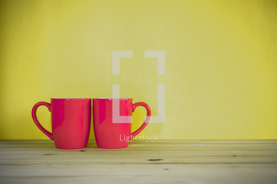 two red mugs 