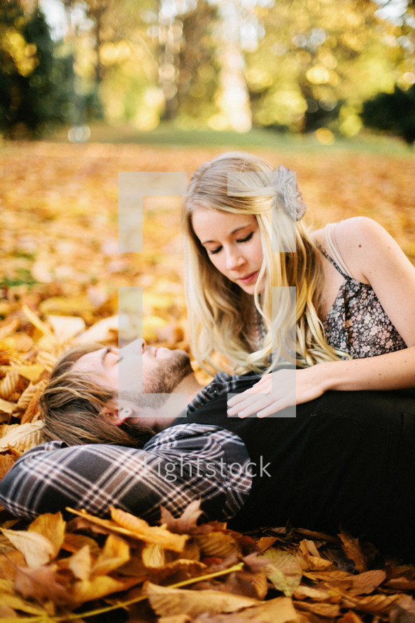 Couple lying in Fall leaves