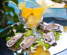 Oysters with lemons on mirror table