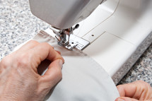 seamstress working on sewing machine.