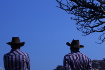 cowboys standing outdoors 