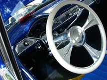 Chrome steering wheel in a vintage car.