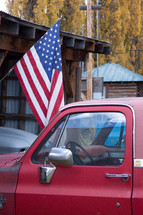 A red truck and an American flag