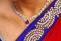 A woman wearing an ornate dress and jewelry.