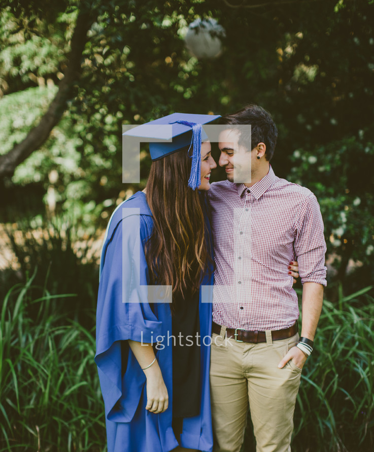Embraced couple at graduation.ad