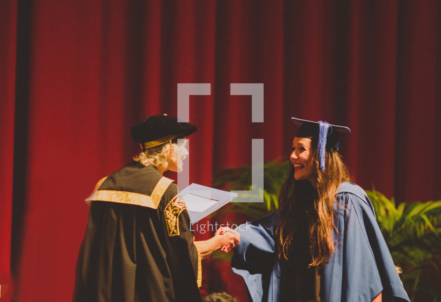 woman receiving her diploma at graduation 