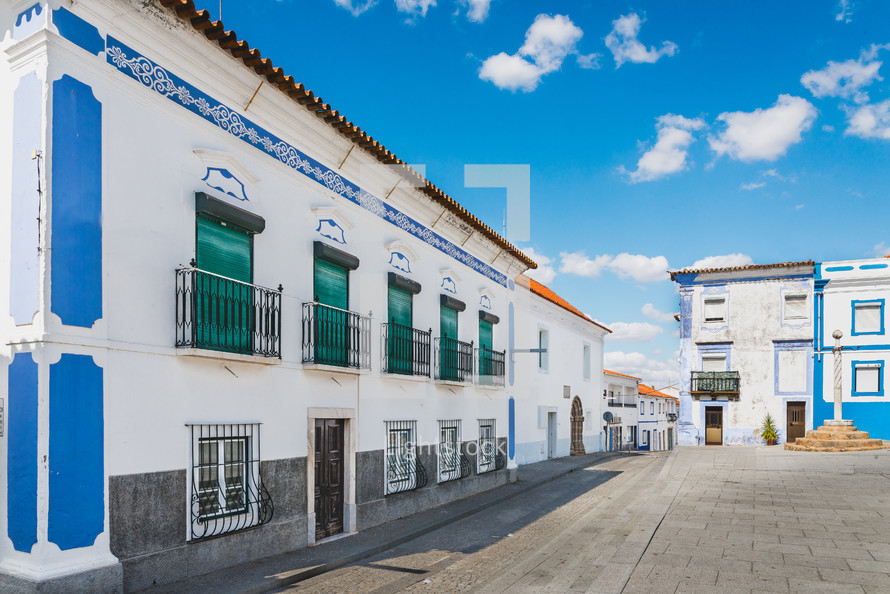blue, white, painted, buildings, along, cobblestone, road, courtyard, balconies 