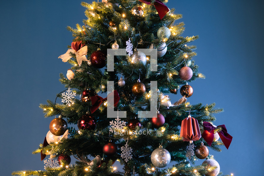 decorated Christmas tree against a blue background 