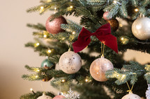 decorated Christmas tree against a cream background 