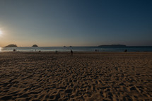 people on El Nido beach at sunset 