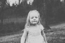 toddler girl standing outdoors 