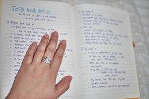 young woman reading a Bible and taking notes 