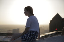 woman sitting on a rooftop 