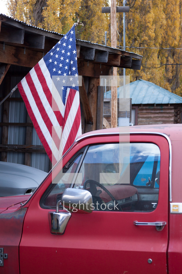 A red truck and an American flag