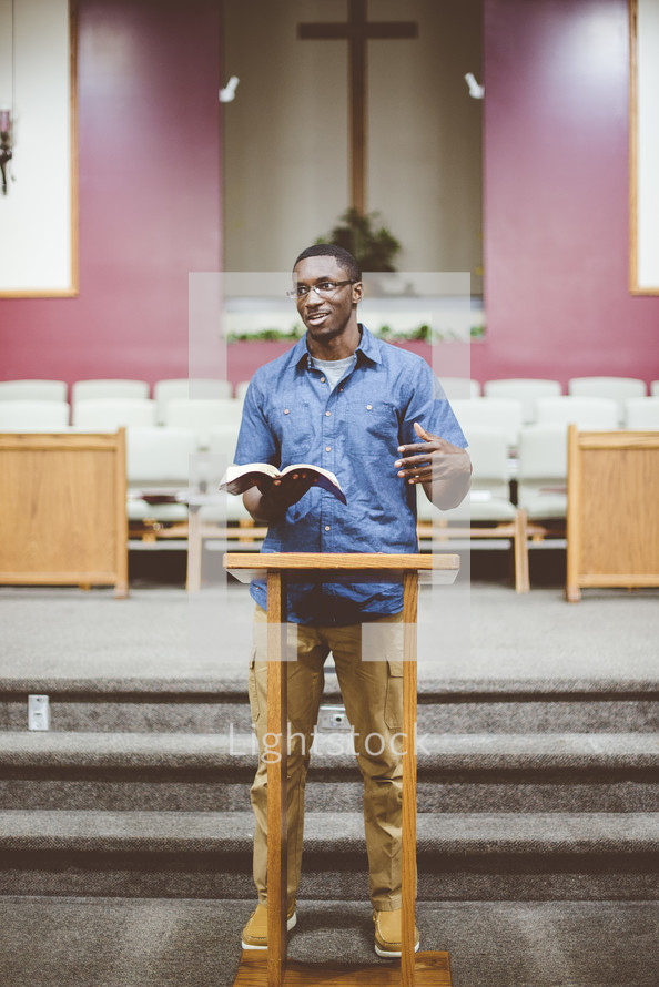 a man reading from a Bible during a worship service