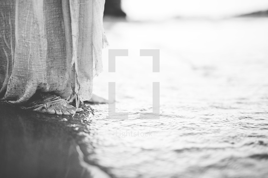 feet of Christ standing on a shore 